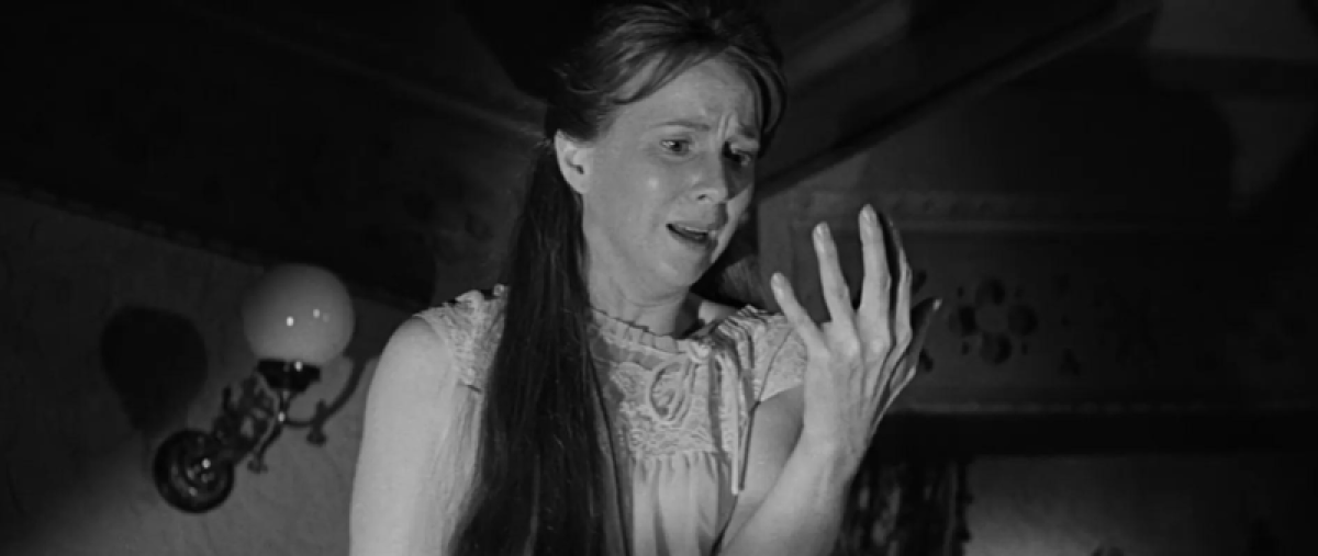 Eleanor looks at her hand, horrified, in The Haunting
