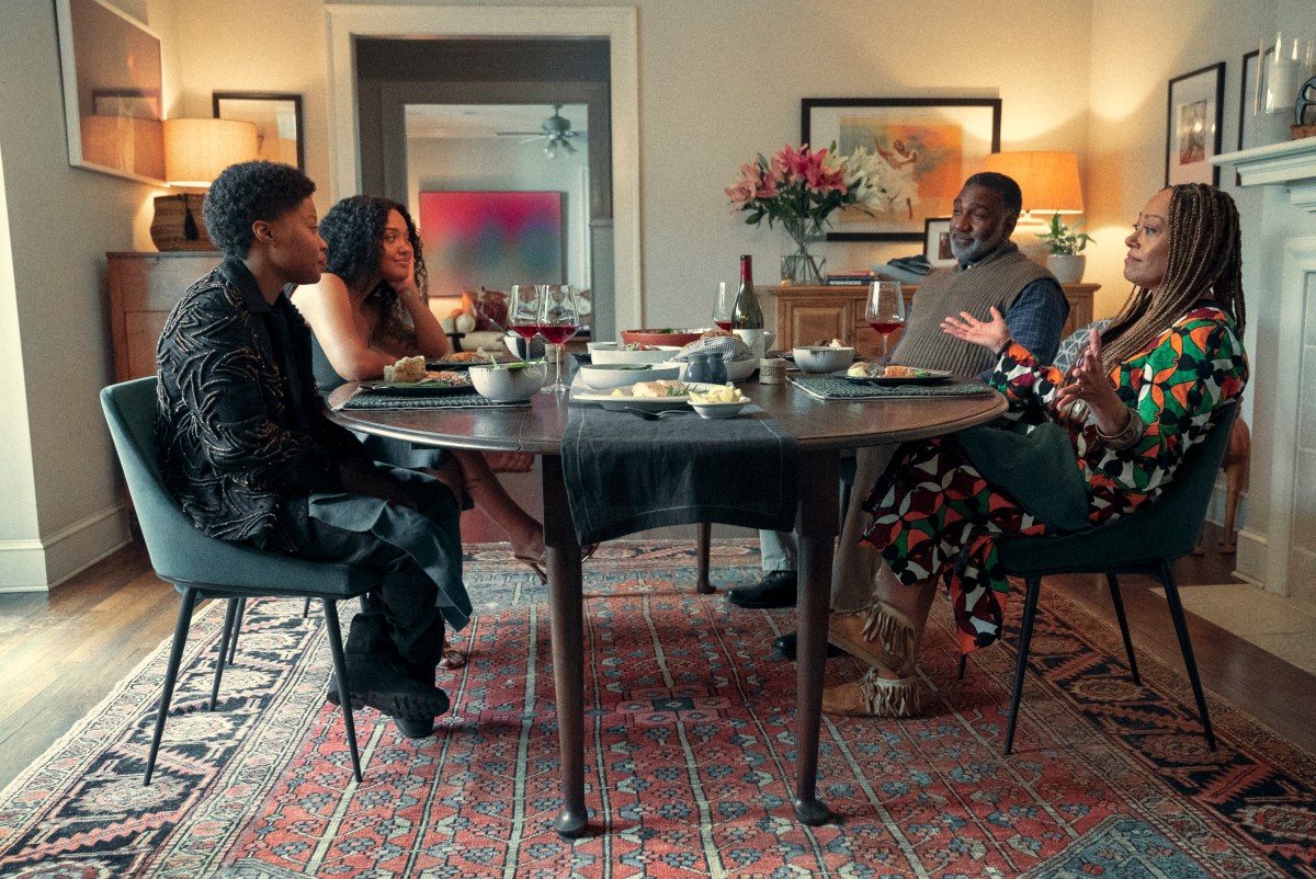 Dre, Rashida and Rashida's parents sit around the dinner table