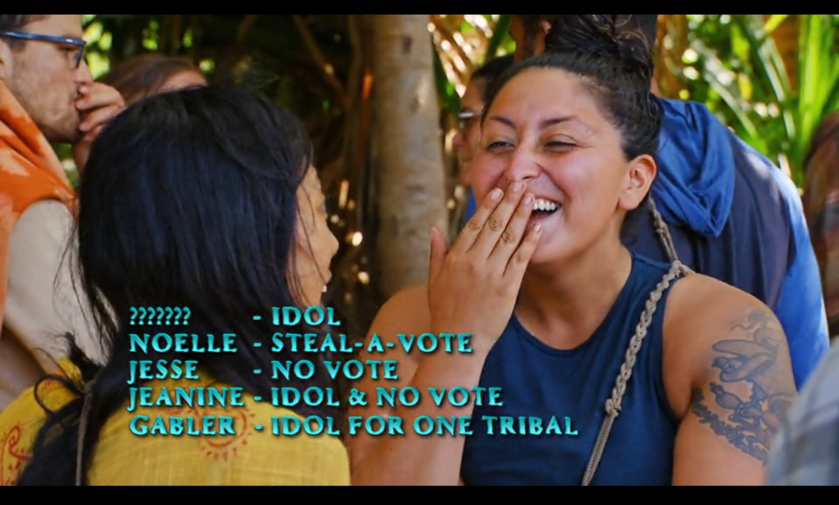 Karla Cruz Godoy giggling while talking to another Survivor contestant, on the bottom of the screen all advantages, disadvantages and idols currently at play are listed