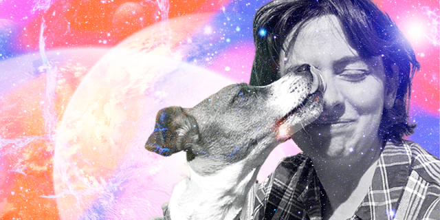 a photo of Sally and her dog penelope. sally is a white woman with medium short brown hair wearing a flannel shirt. her eyes are closed because penelope is licking one of them. they are set against a spacey background