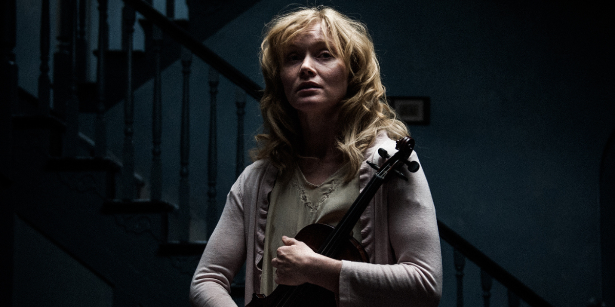 Amelia in The Babadook cradles an instrument
