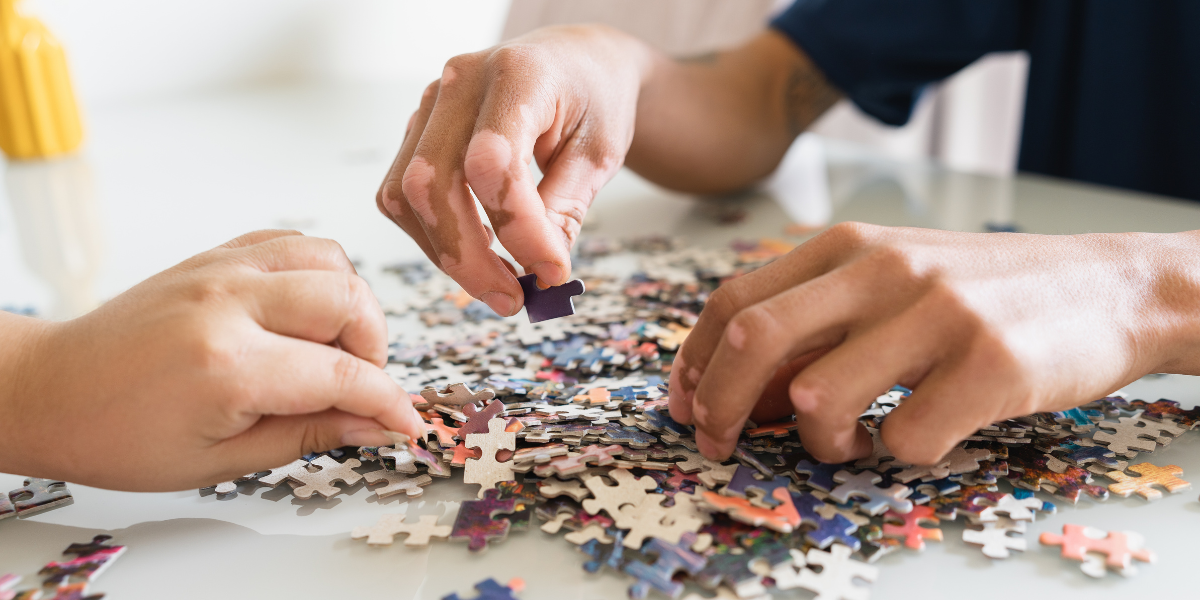 Hands searching for puzzle pieces