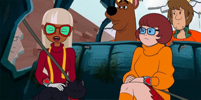 Coco and Velma sit beside each other in the Mystery Machine