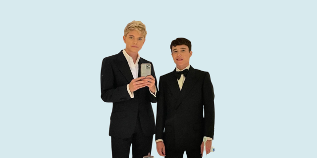 Mae Martin and Elliot Page take a mirror selfie in suits