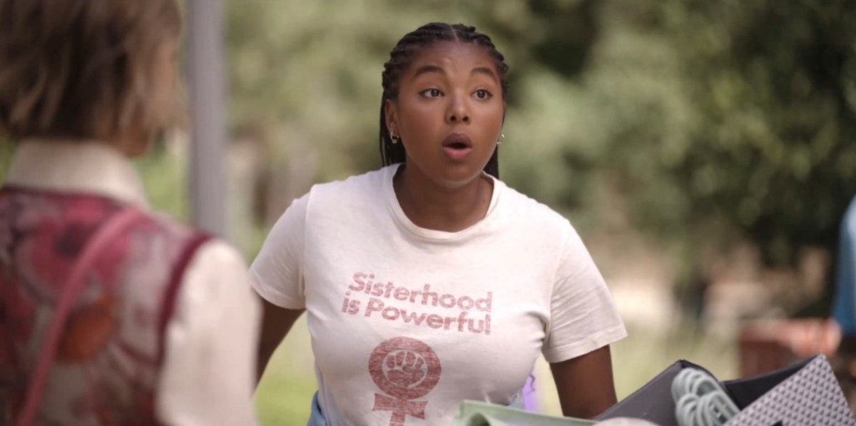 Angie approaching her pals in a Sisterhood is Powerful t-shirt