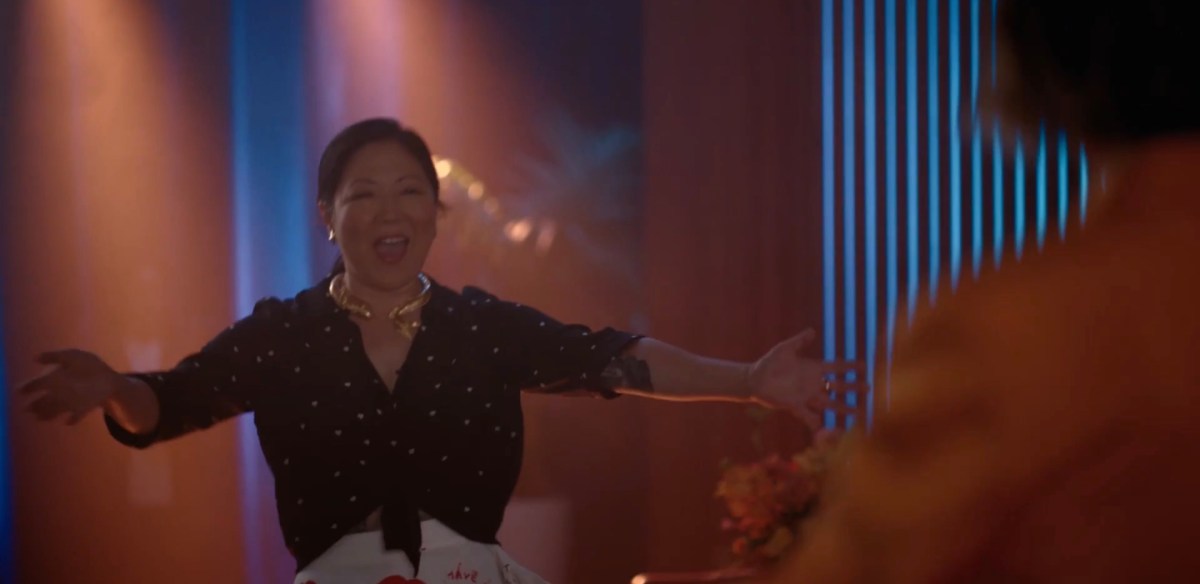 Margaret Cho coming onto stage with her arms outstretched