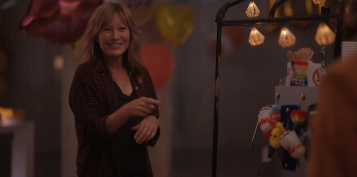 Taylor in a flannel shirt, cutely pointing at Alice