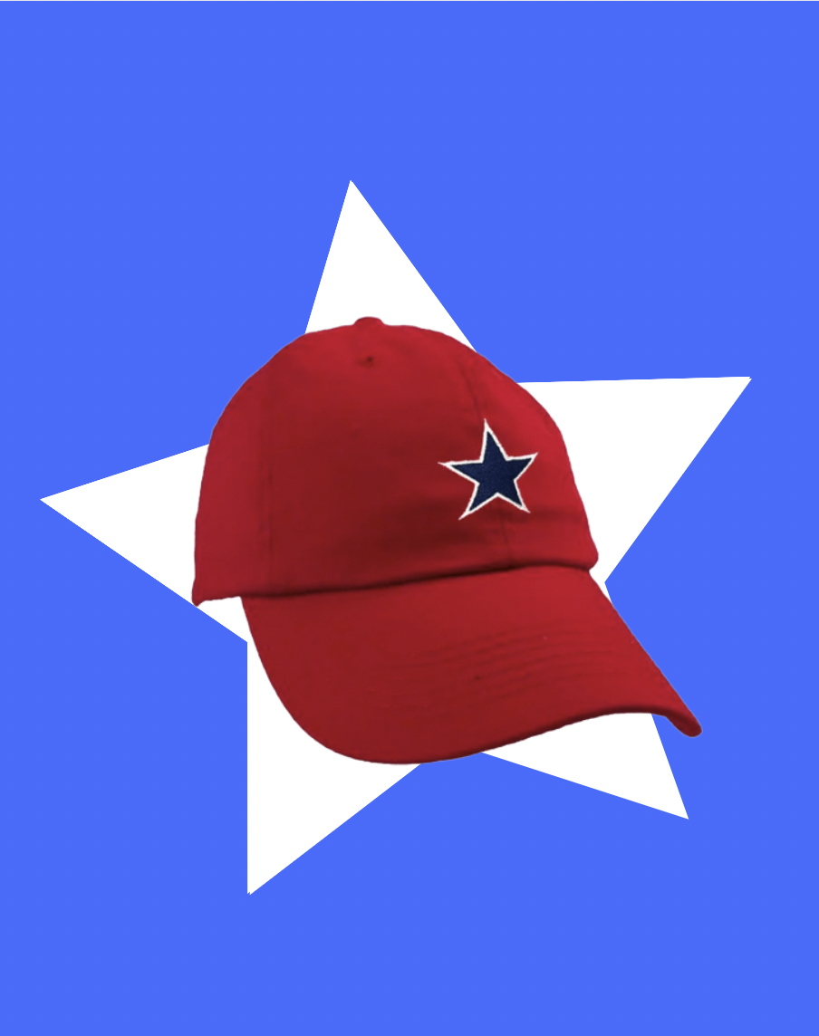 The All Stars Cap on a blue background. The Cap is retro red with an embroidered navy star. The star is outlined with white stitching. It's super cute and simple! This cap represents Max Chapman's baseball team, Red Wright's All Stars, one of the main teams in the 2022 tv show "A League Of Their Own."