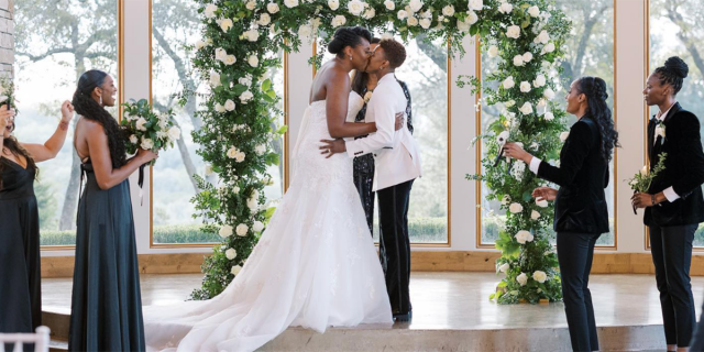 Andrea Mingo and Danielle Robinson kiss on their wedding day