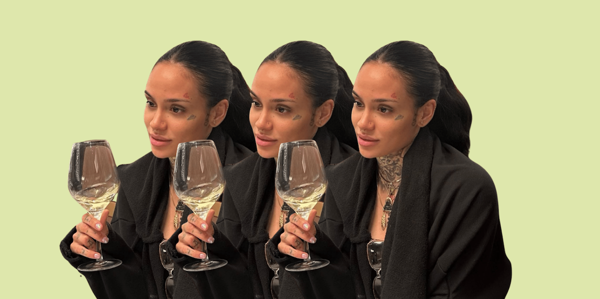 Kehlani holds a wine glass against a green background