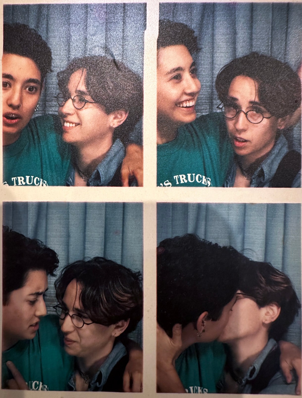 Tracy and Mia pose for a series of photo booth photos. They're in color. Tracy has short hair, Mia has a kind of 90s hearthrob haircut and small wireframe glasses and is wearing a collared shirt. Tracy is wearing a tee. They make a variety of different, cute faces.