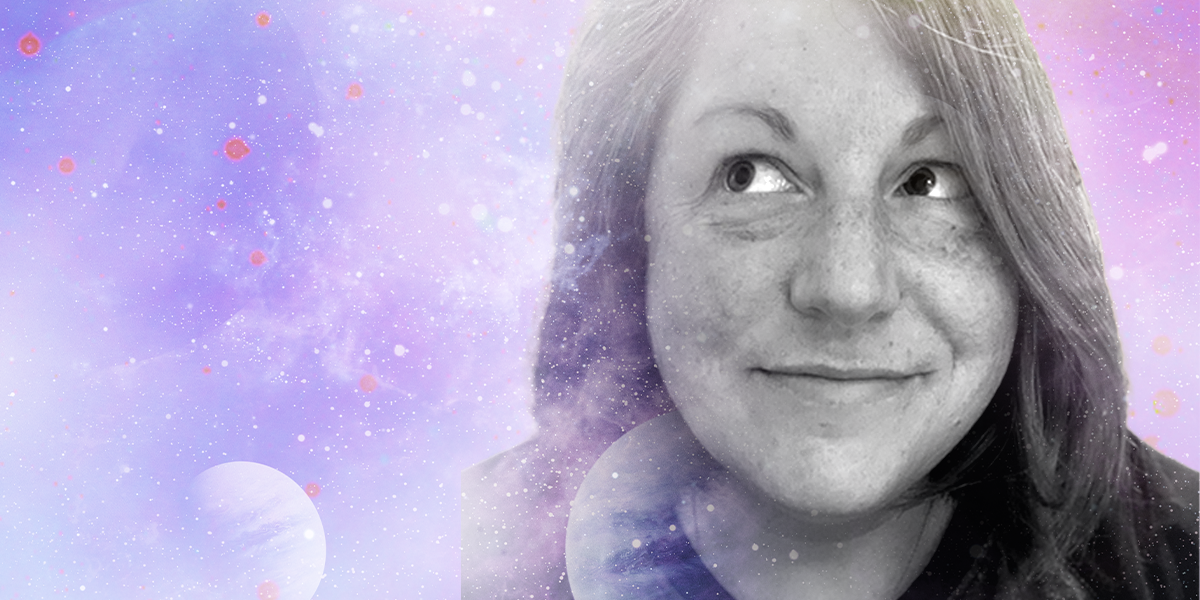 Darcy, a white human, smiles and looks up and to the right. They have medium length brown hair and are set in black and white against a colorful spacey backdrop.