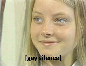 A young Jodie Foster licking her lips and cocking her eyebrow. Text reads: [gay silence]
