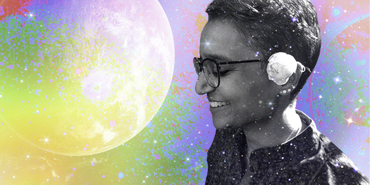 Himani, a South Asian woman with short wavy hair and glasses smiles with a flower in her ear. She is set in black and white against a spacey, colorful background.