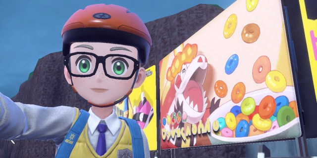A Pokemon trailer with green eyes, square glasses, and an orange bike helmet standing front of a billboard of Fuecoco eating cereal