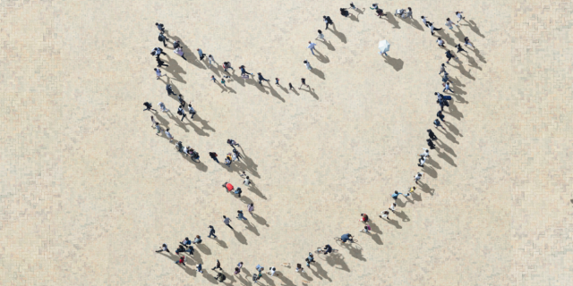 An aerial shot of people standing looks like the Twitter bird icon