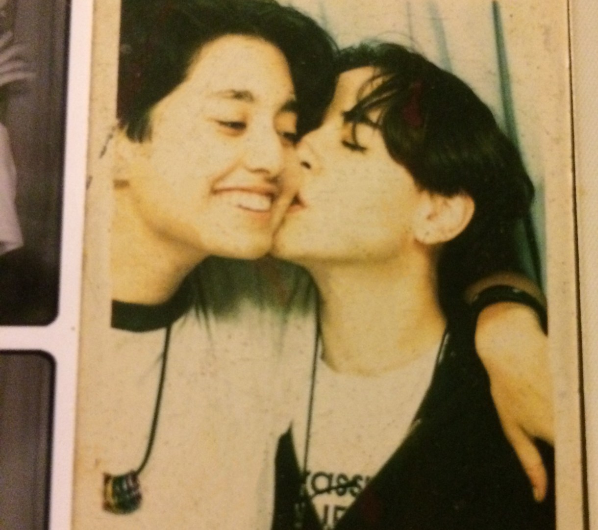 an older snapshot of Mia kissing Tracy's cheek and Tracy grinning