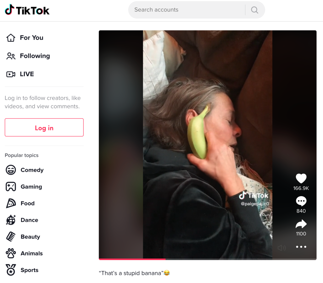 screenshot of a tiktok video of a woman holding a banana instead of a phone