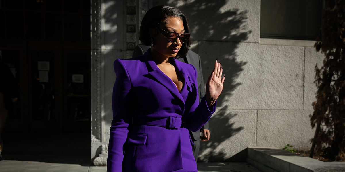 Megan Thee Stallion whose legal name is Megan Pete makes her way from the Hall of Justice to the courthouse to testify in the trial of Rapper Tory Lanez. She is wearing a purple pantsuit and sunglasses.