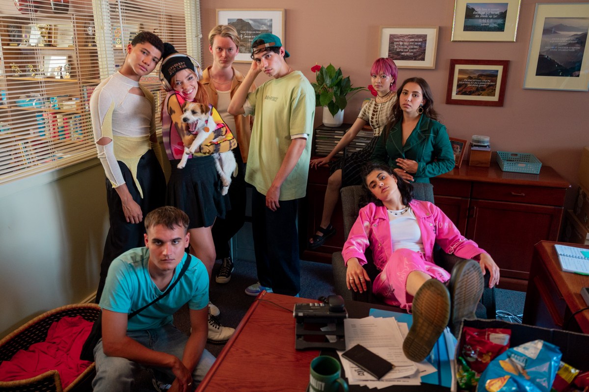 Cast of heartbreak high posing in a school office