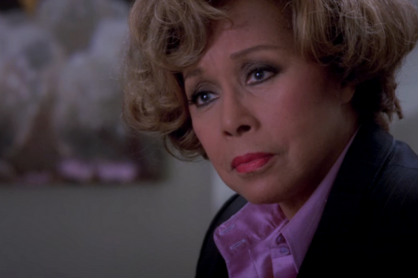 Mama Burke on Grey's Anatomy wearing a satin purple buttondown