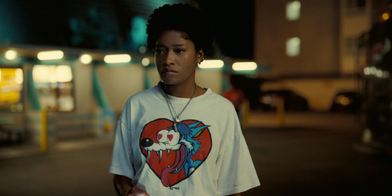 Keke Palmer in Nope wearing a white shirt with a red heart and cartoon wolf in the center.