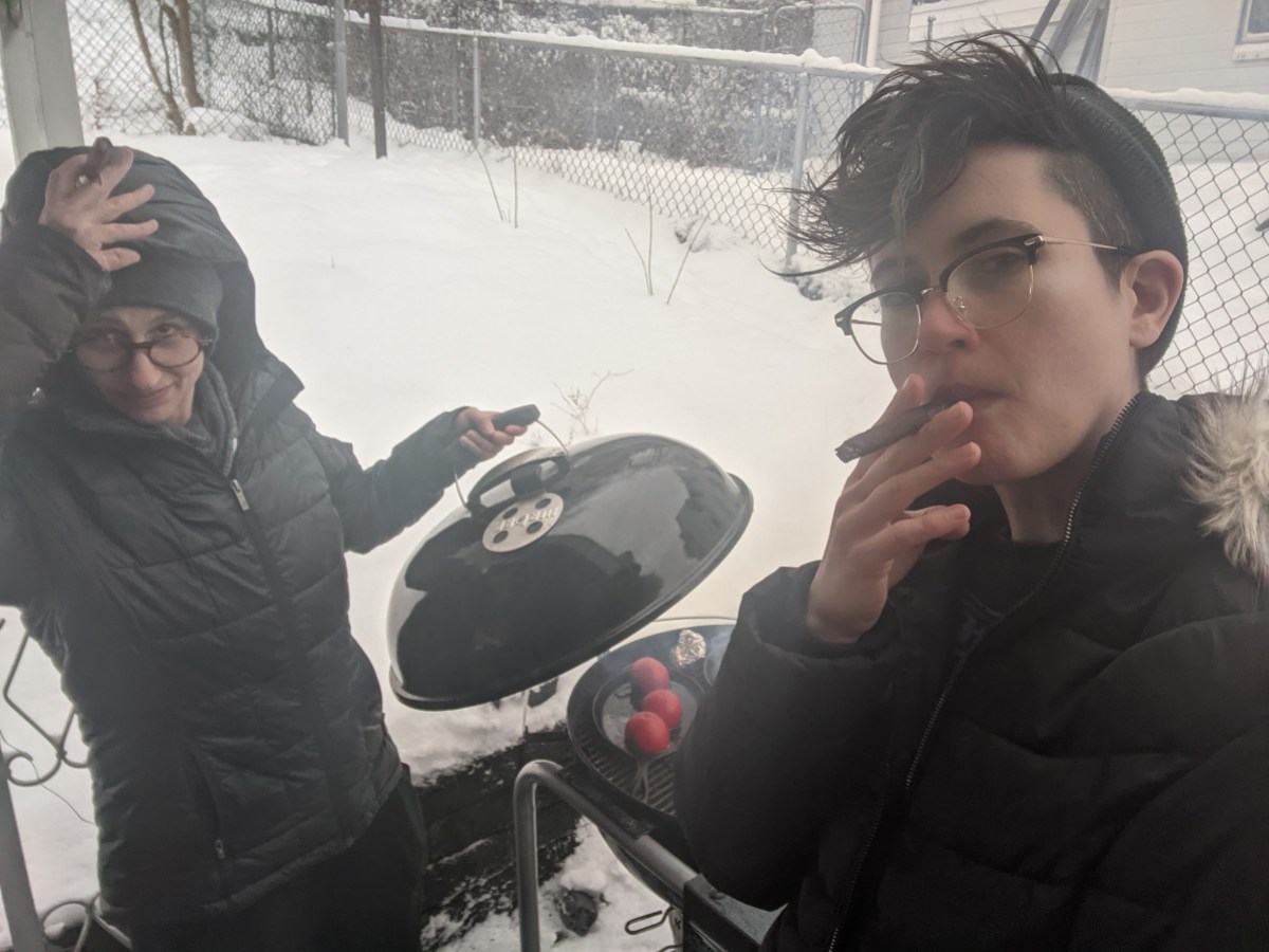 nico and sadie grill outdoors in the snow, smoking cigars