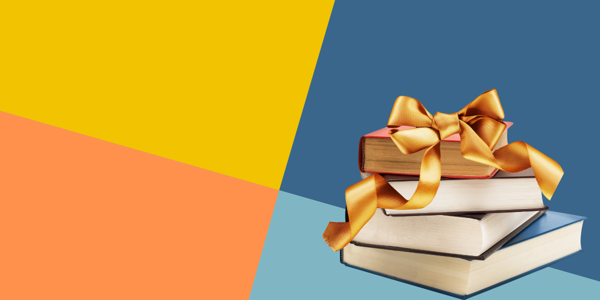 A stack of books with a gold bow on top
