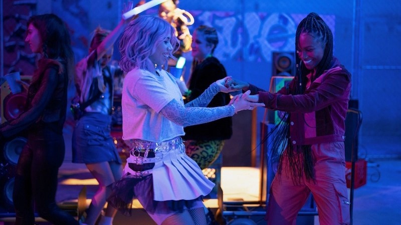 Naomi and Lourdes dance at a club