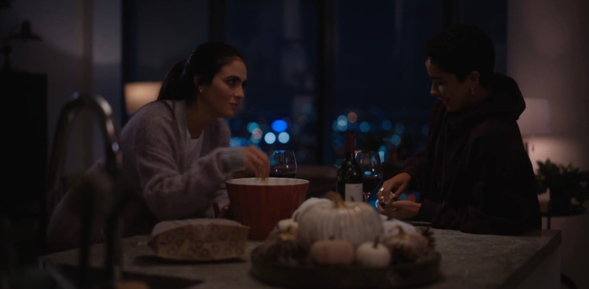 Roxy and Dani eating popcorn at the kitchen counter