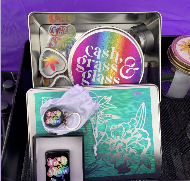 This weed themed gift set contains: 1 large floral stash box 1 medium “cash, grass, or glass” stash box 3 small I <3 weed bud boxes 1 “smokeshow’ grinder keychain 1 ‘smokeshow’ zippo-style lighter 1 purple flames bic style lighter 2 holographic stickers 