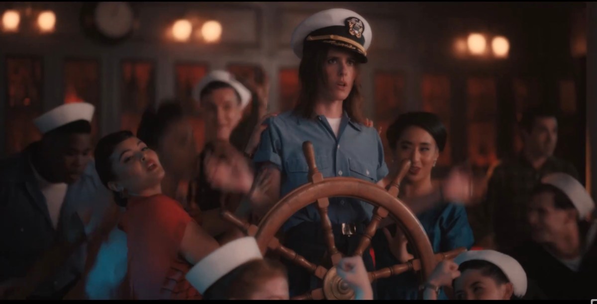 Shane at the captain's wheel in a crooked hat surrounded by damsels