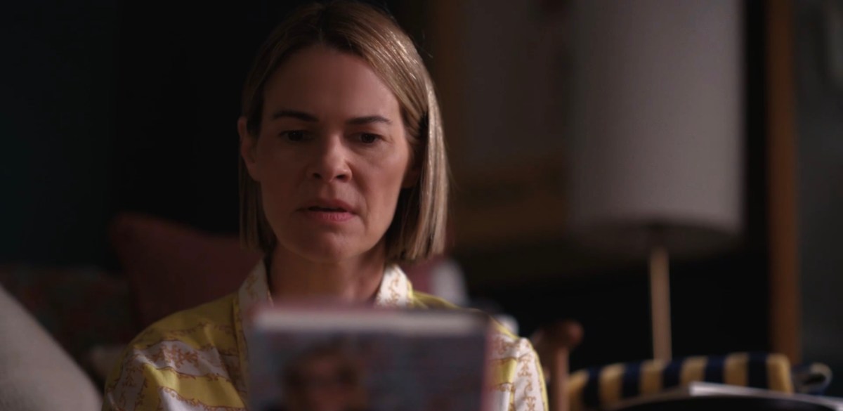 Alice looking at her own book in wonder