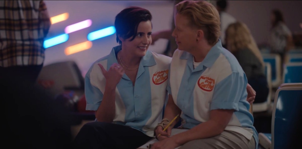 Finley with her arm around Misty pointing behind her with her thumb