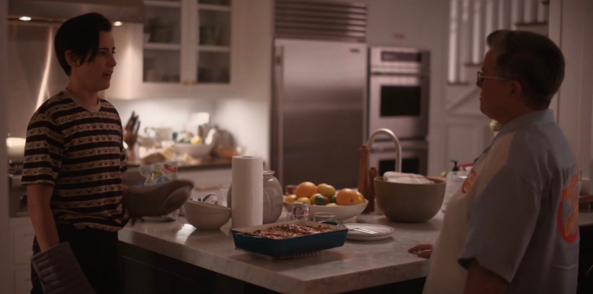 Finley and Carrie in the kitchen with the lasanga between them