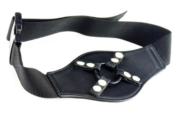 A black thigh harness with a pleather center, a rubber ring held in place with snaps, and a fabric strap
