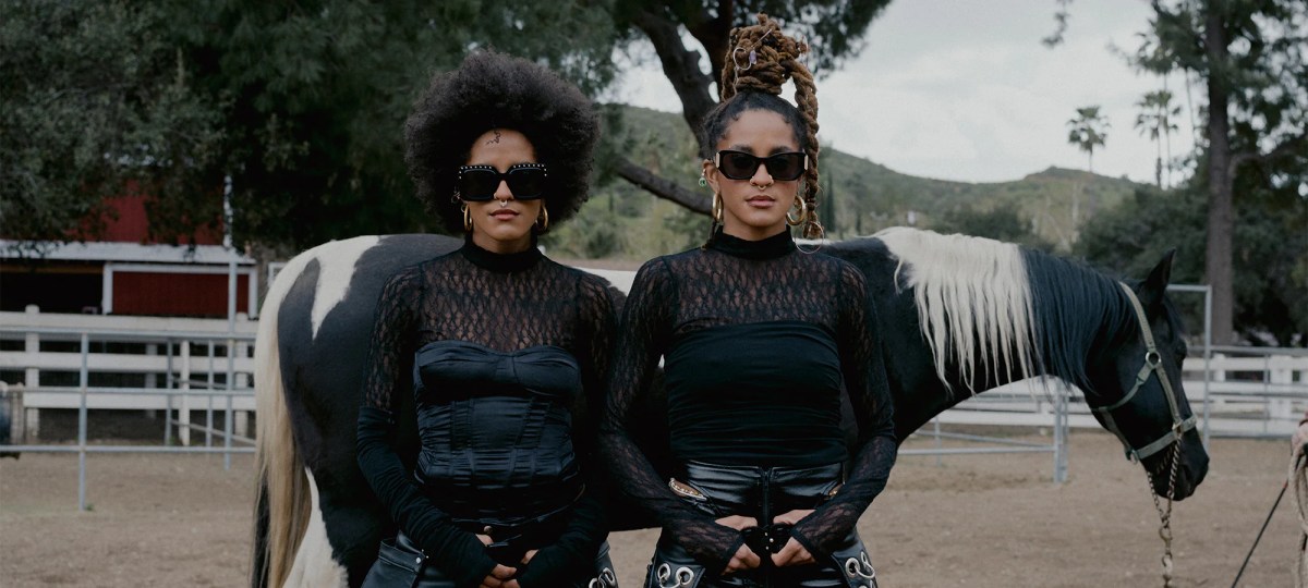 coco & breezy models in sunglasses in front of a horse