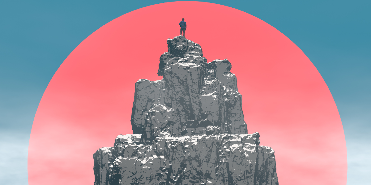 A person stands on a cliff