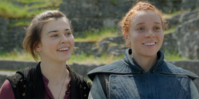 Jade and Kit smile while standing right next to each other