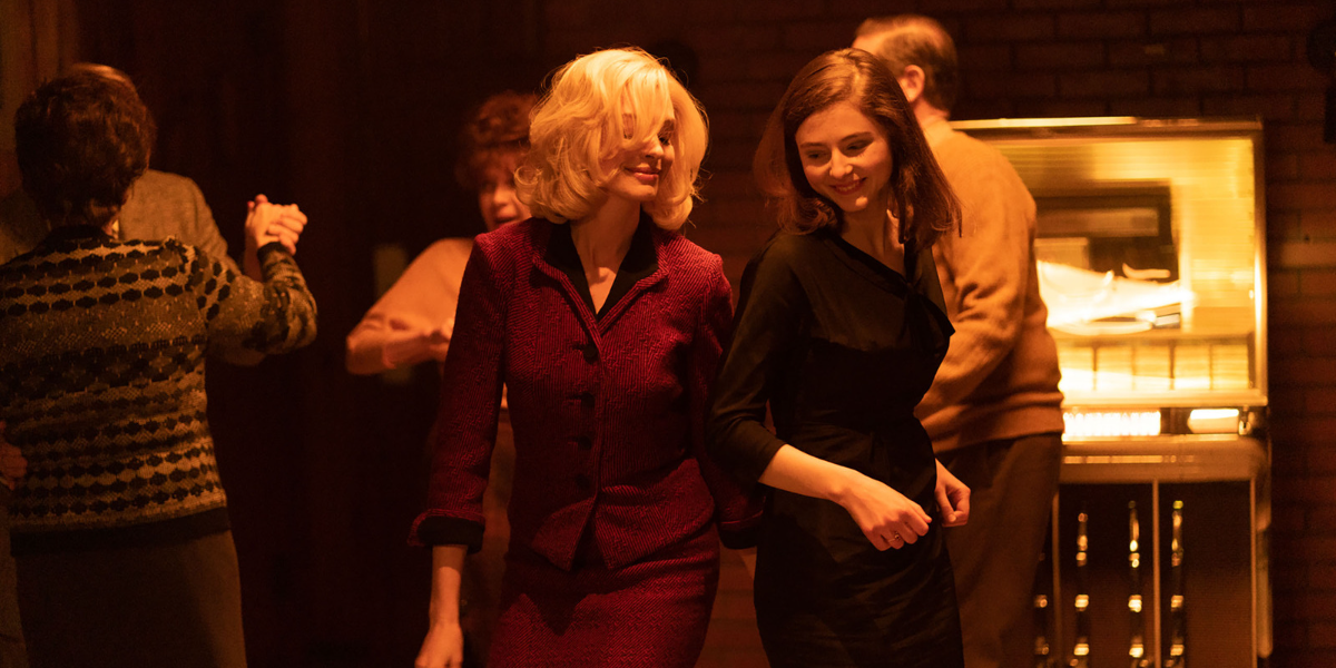 A still from "Eileen" where two women dance in a bar.