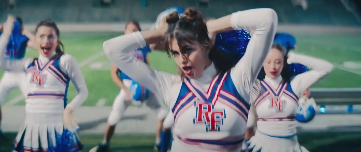 Kaia Gerber dancing in a cheerleader uniform