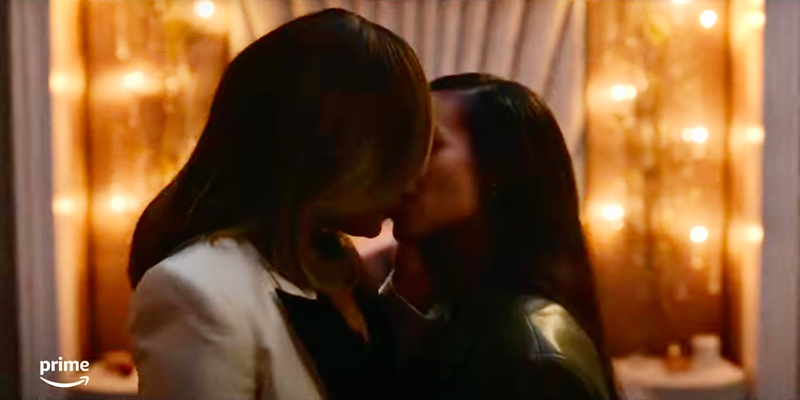 Harlem Season Two: Two Black women kissing in front of a golden backlit background
