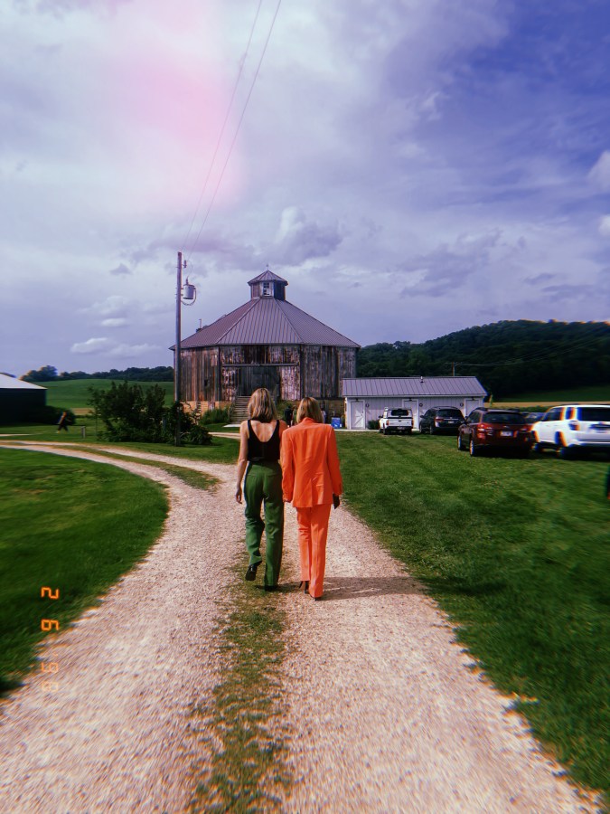 gretchen and riese, backs to the camera, walking down a country road