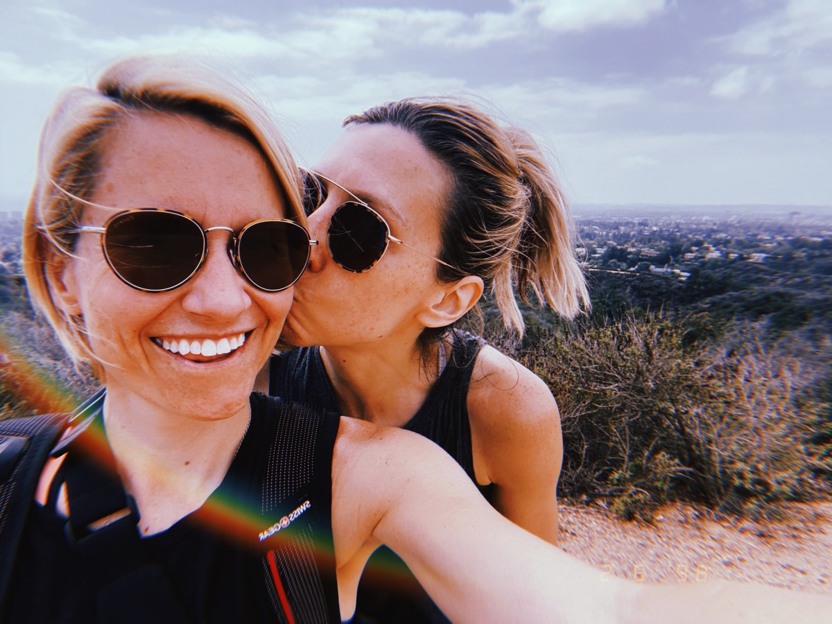 riese and gretchen on a hike in Los Angeles, riese kissing gretchen on the cheek