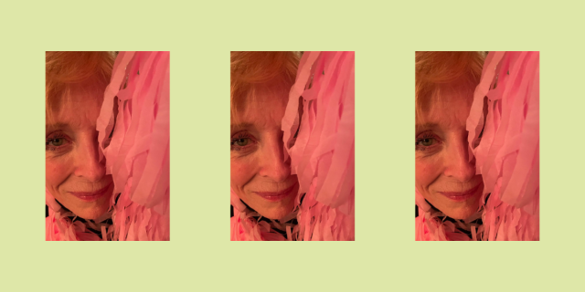 Holland Taylor poses behind pink streamers against a green background