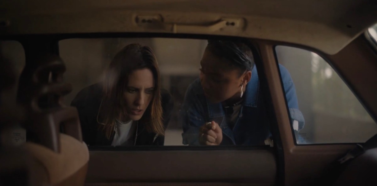 Shane and Angie looking through the car window