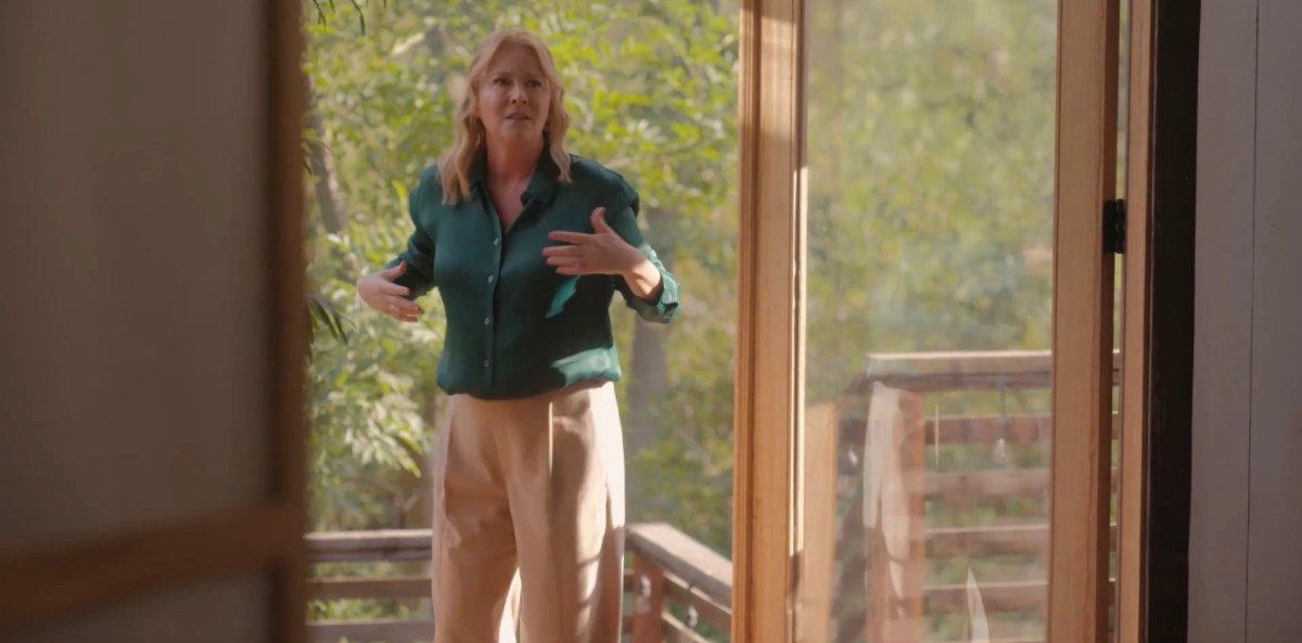 Tina uncomfortable on the porch in a green silk shirt