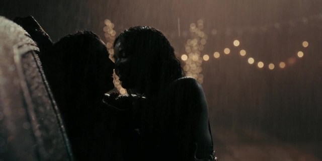 Gabrielle Union kissing another woman in the rain, pressed up against her SUV