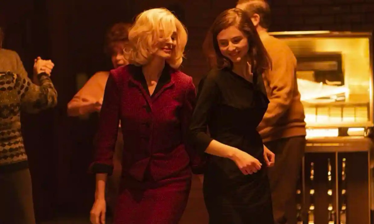 A still from "Eileen" where two women dance in a bar.
