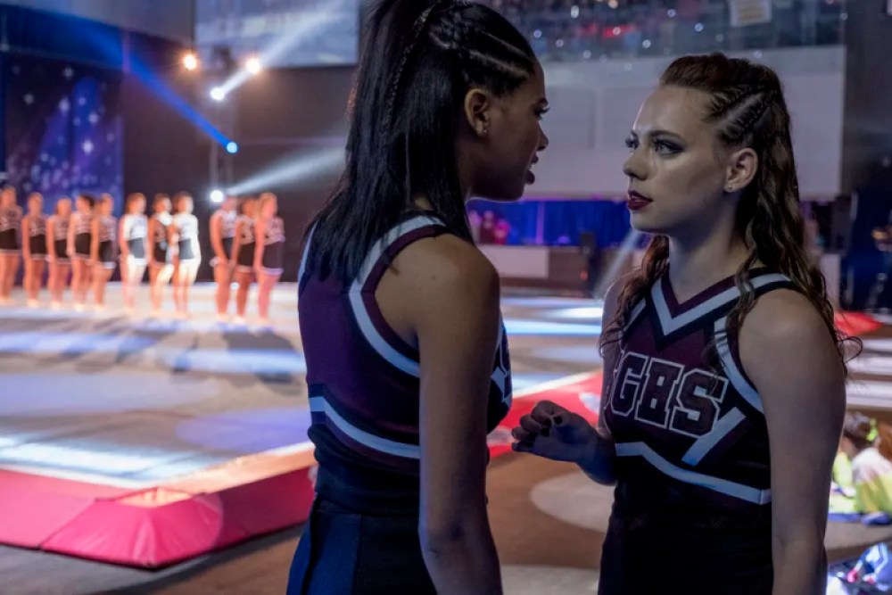 Addy and Beth are in their cheerleading uniforms in the show Dare Me
